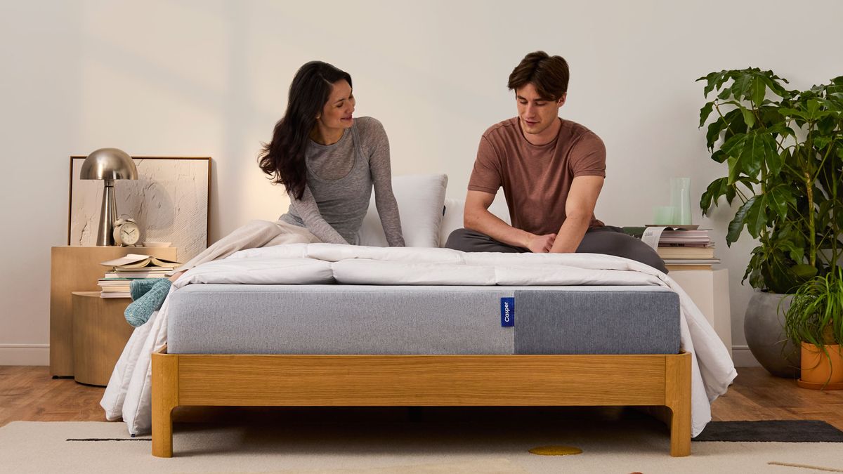 A couple sitting on The Casper mattress