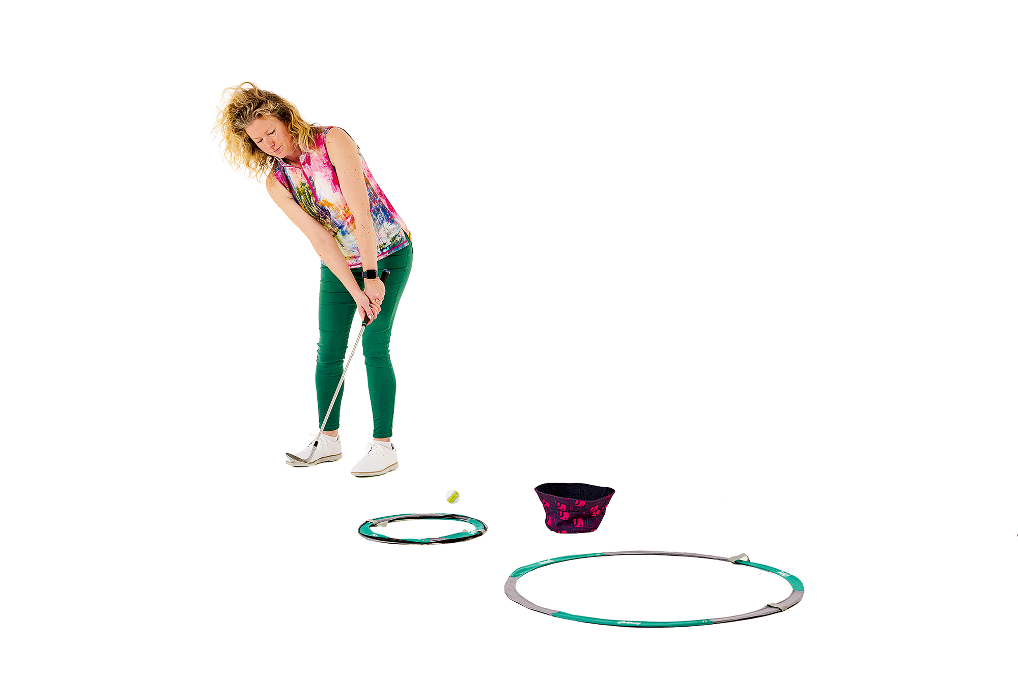 Katie Dawkins demonstrating a fun practice game where you chip into different zones using household items or training aids