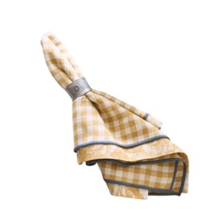 A folded yellow gingham napkin with blue trimming and a silver napkin ring on it