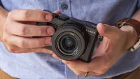 The Panasonic Lumix LX100 II being held in two hands