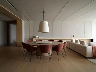 A dining cum living room with hardwood flooring