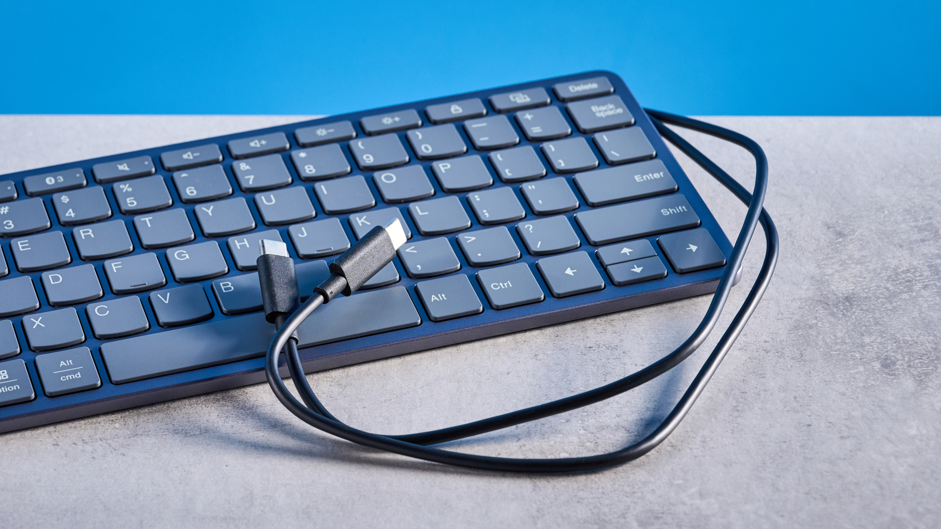 Lenovo Multi Device Keyboard photographed in front of a blue background.