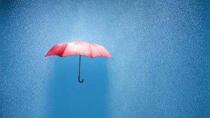 red umbrella with blue background and rain