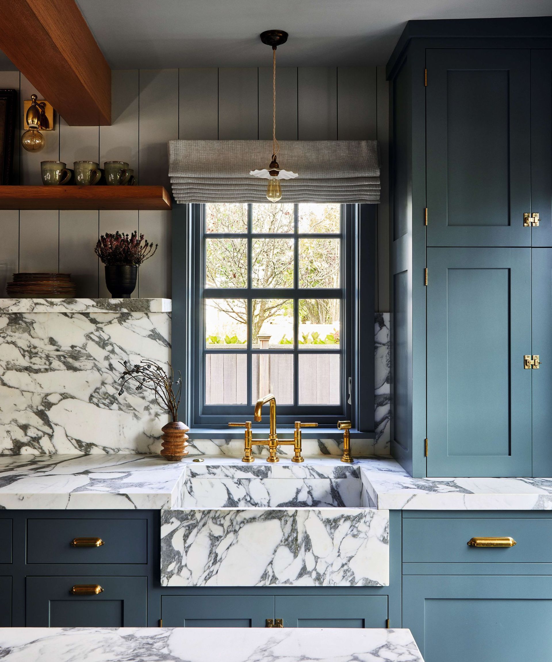 Blue kitchen with marble worktop