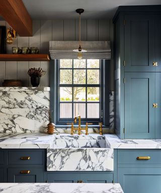 Blue kitchen with marble worktop