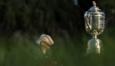 John Daly sits next to the PGA Championship trophy
