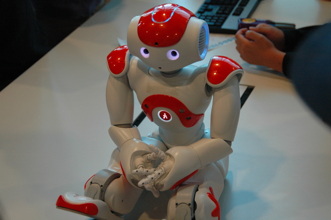 A dancing robot poses shyly for the camera during Robotronica robotics event at Queensland University of Technology.