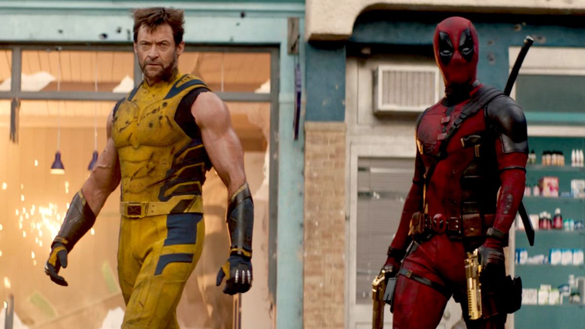 Hugh Jackman as Wolverine and Deadpool walking in front of a damaged store during the Marvel movie Deadpool and Wolverine.