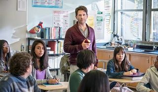 A.P. Bio Glenn Howerton eats an apple, scowling in the middle of a classroom of kids