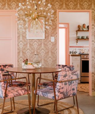 eclectic dining room with seventies style wallpaper, round dining table and upholstered crane retro chairs, round coir rug, retro pendant light, view t