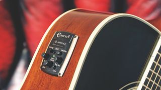 Close up image of acoustic electric guitar controls