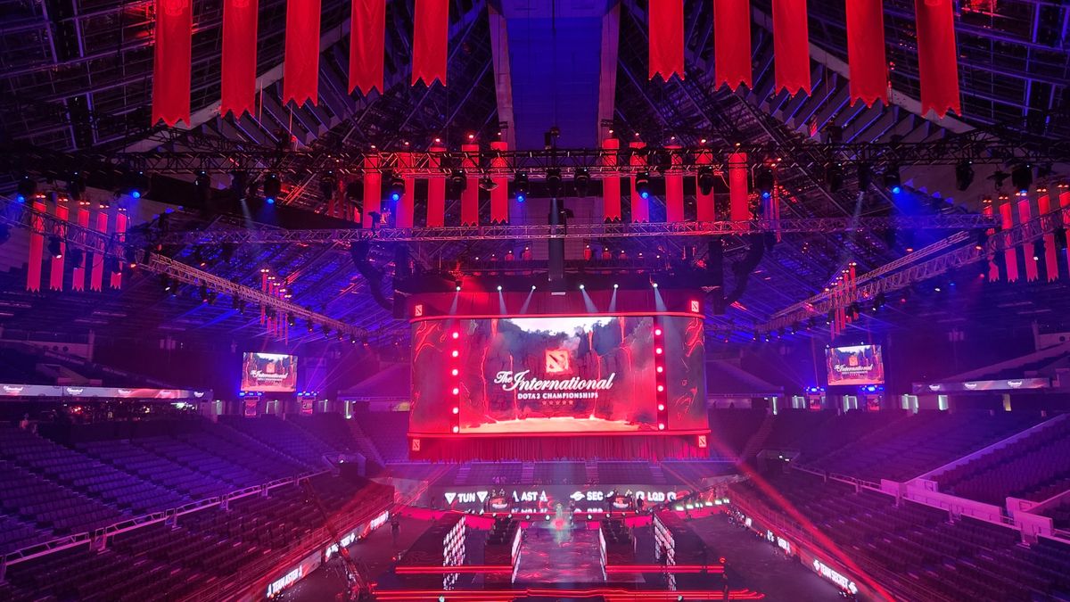 An esports arena lit up in blue, red, and purple lights with immersive sound from d&amp;b Soundscape.