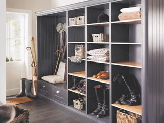 boot room with grey cabinets and slate floor