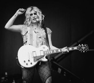 Kesha with a guitar