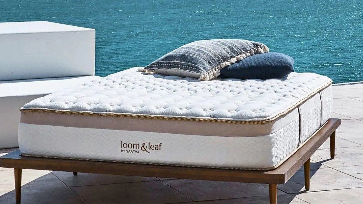 Saatva Loom &amp; Leaf memory foam mattress overlooking a blue ocean