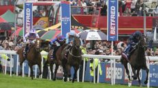 Image shows the action at the 2025 Derby. Winner Lambourn leads the field home in front of the crowds.