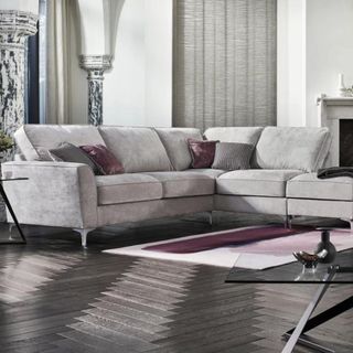 A grey corner sofa sitting in a grey living room
