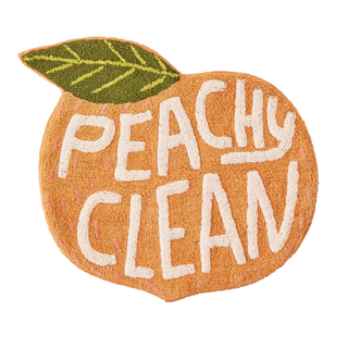 A peach-shaped bath mat that says 
