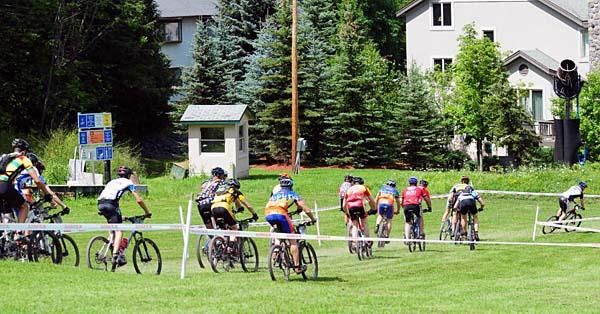 Riders descend a new grass section of the start.