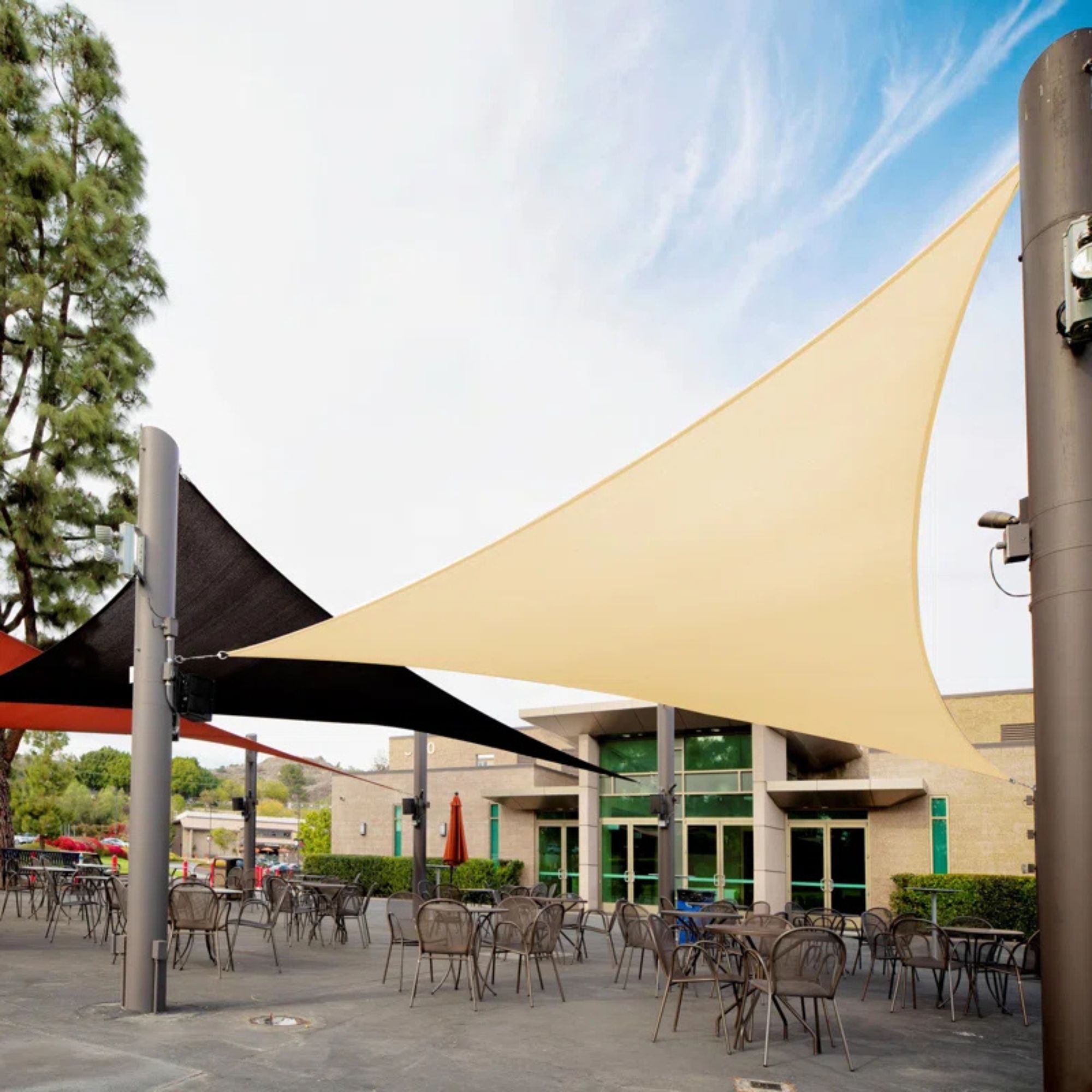 Royal Shade Triangle Sail over chairs against a blue sky. 