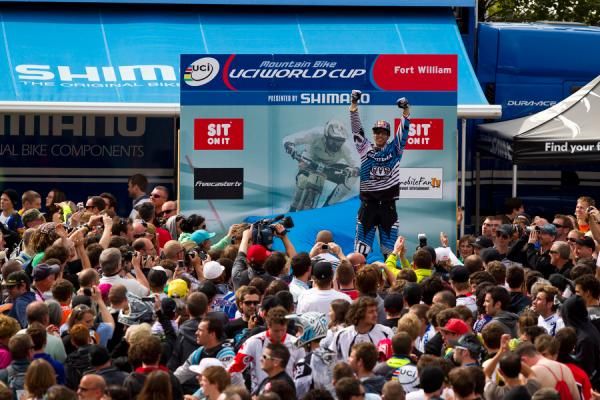 Gee Atherton atop the downhill World Cup podium in Fort William.