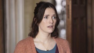 Charlotte Ritchie in a peach cardigan as Alison in Ghosts.