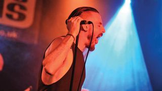 Caligula's Horse frontman Jim Grey singing on stage