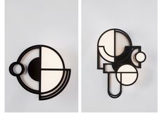 Two wall lights by Lara Bohinc for Roll & Hill featuring geometric shapes in black anodised aluminium