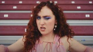 Chappell Roan sings in the "HOT TO GO!" music video