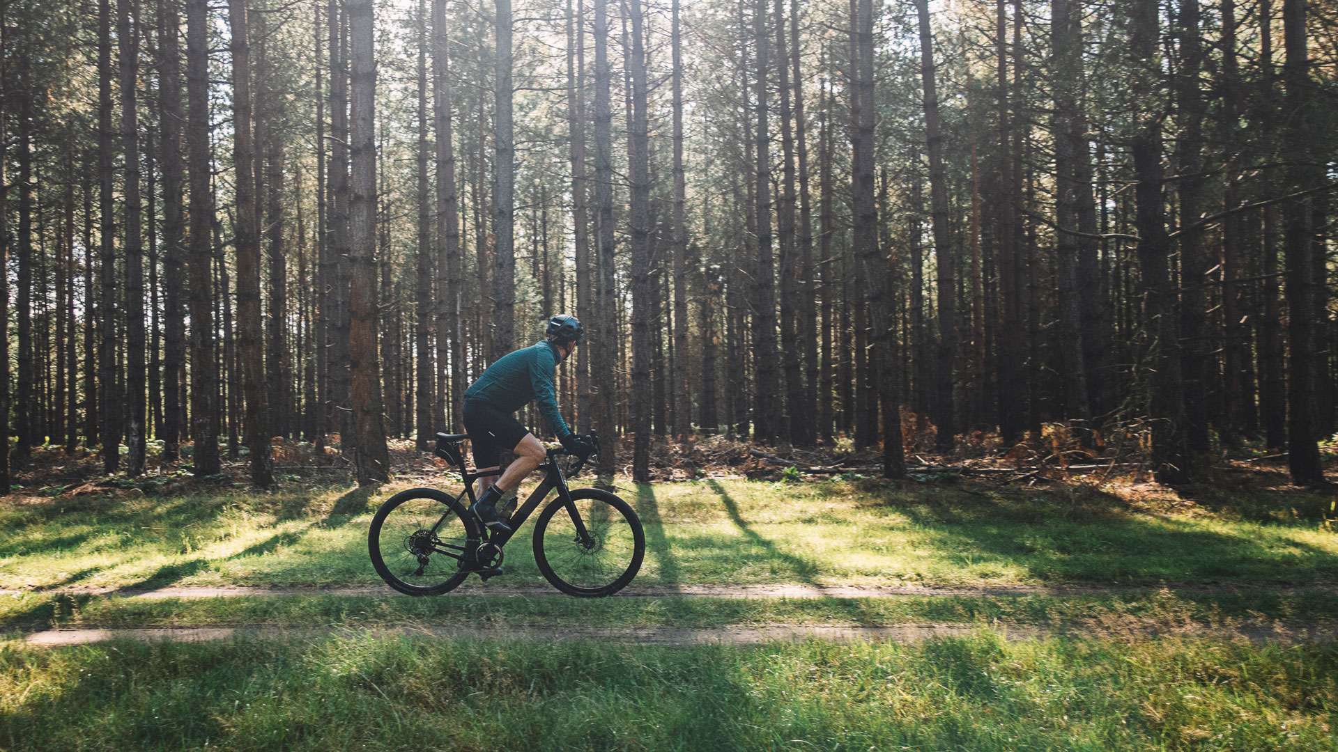 A man riding a bicycle through the forest