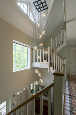 staircase with a large light in centre