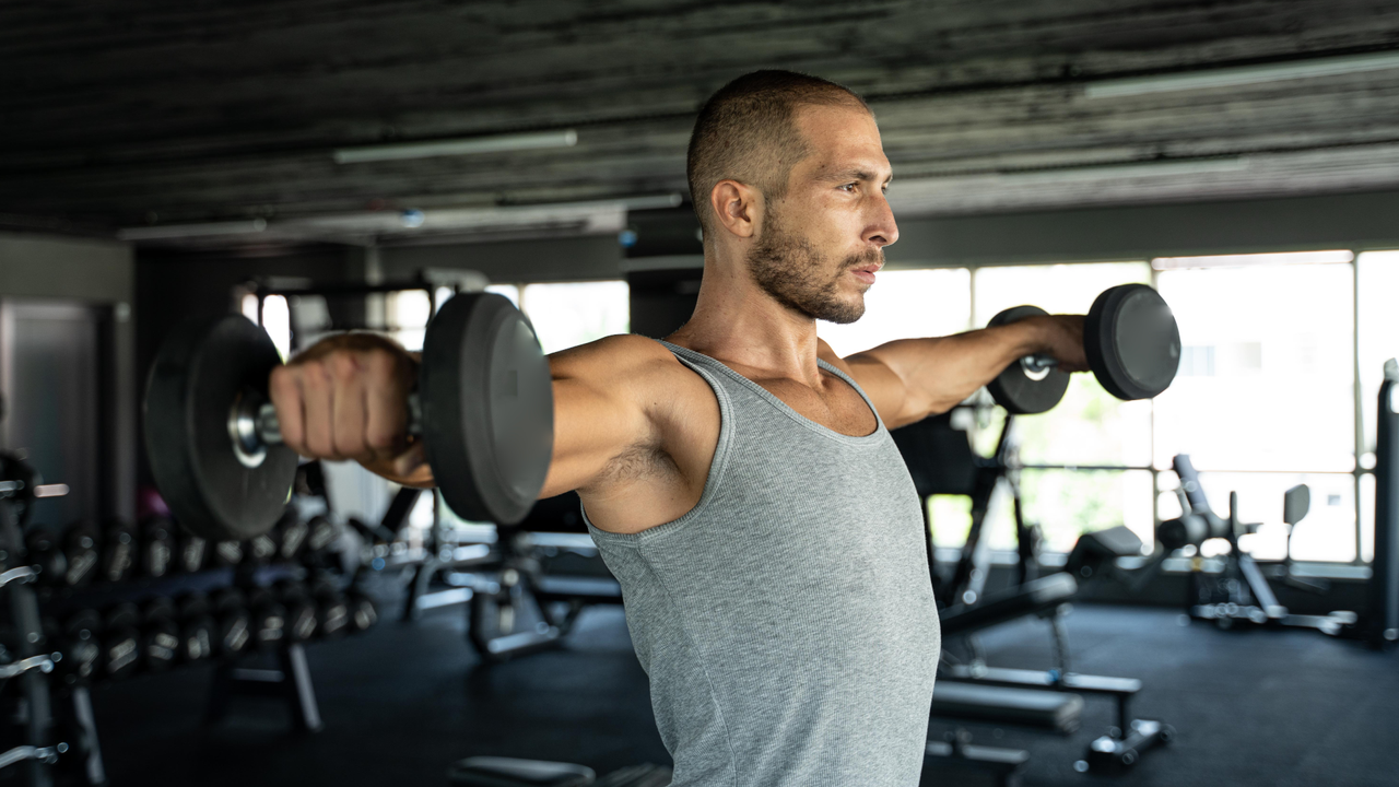 Man doing dumbbell lat raises