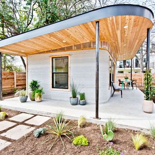exterior of house garden wooden roof and table with chair