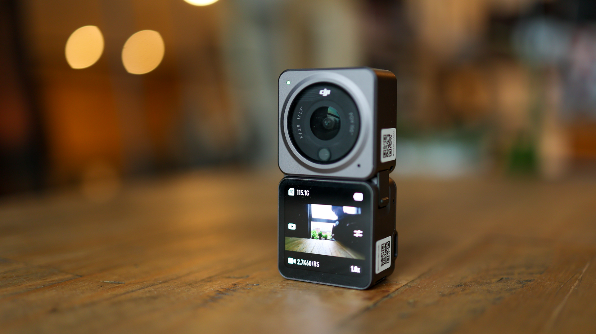 The DJI Action 2 action camera on a table with its display module