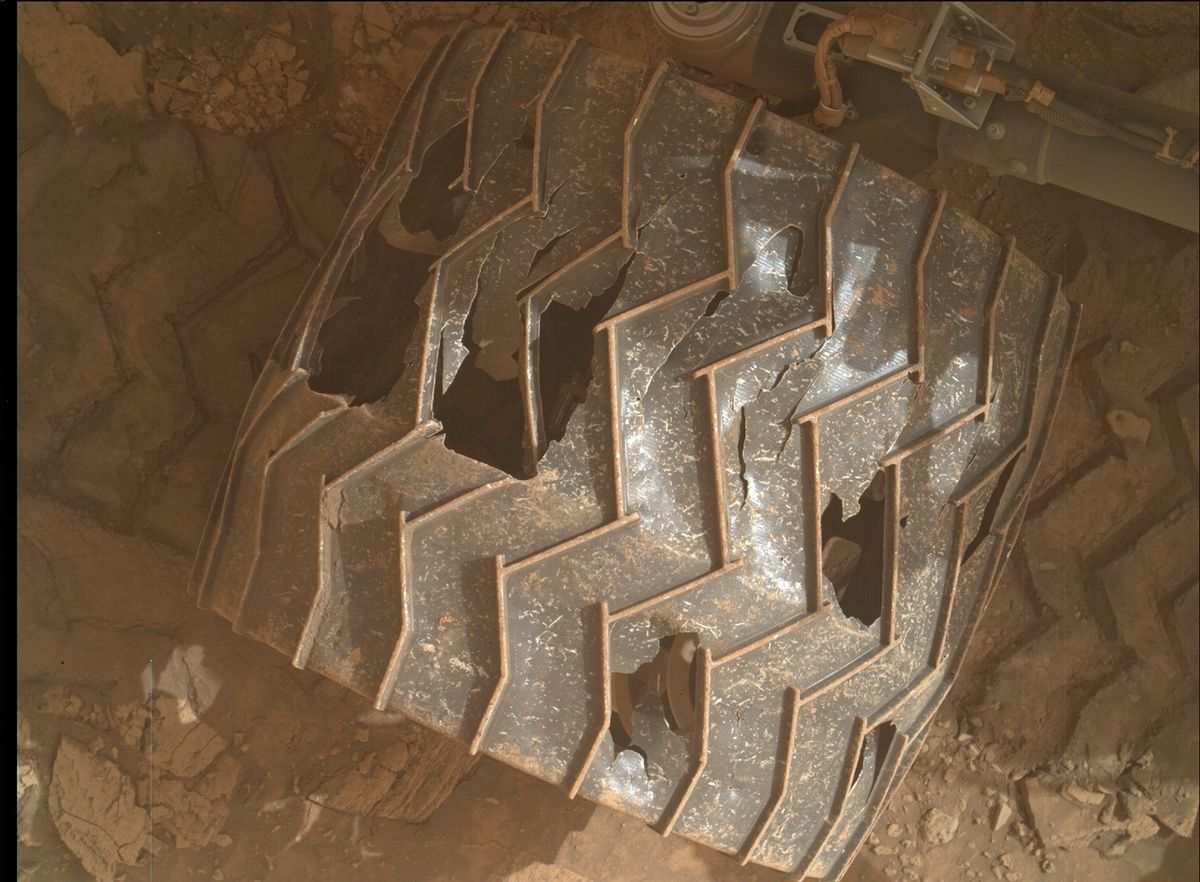 A wheel of the Mars Curiosity rover showing damage from rugged terrain