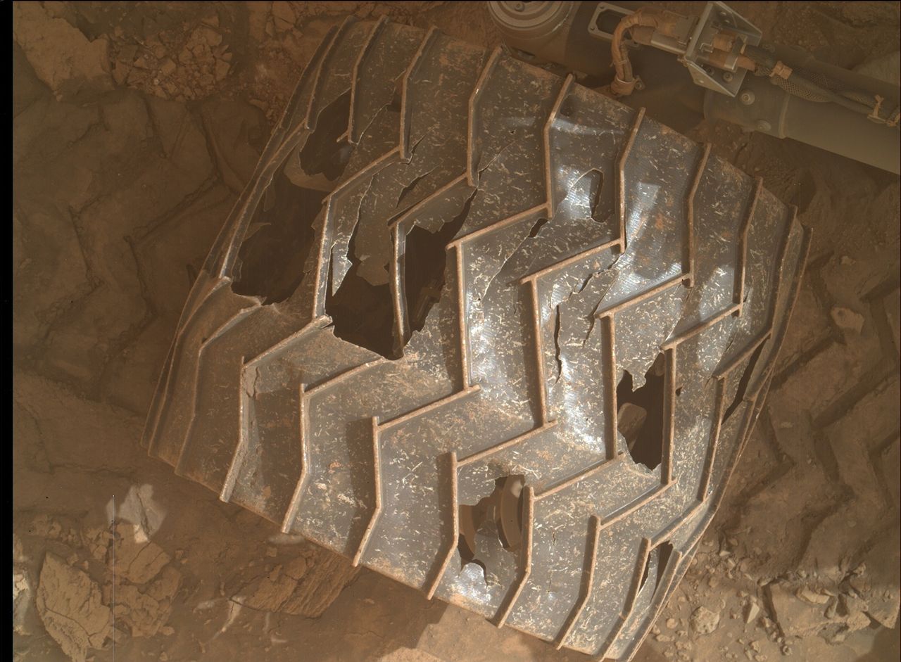 A wheel of the Mars Curiosity rover showing damage from rugged terrain