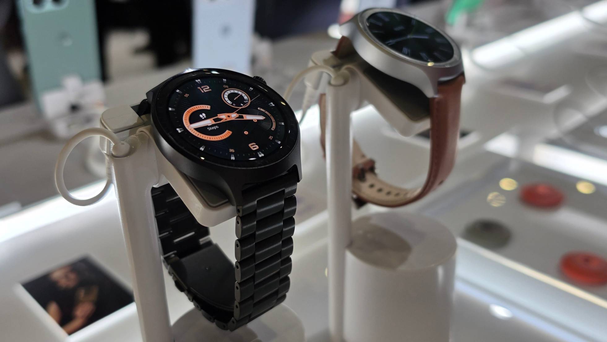 Two Moto Watches on stands.