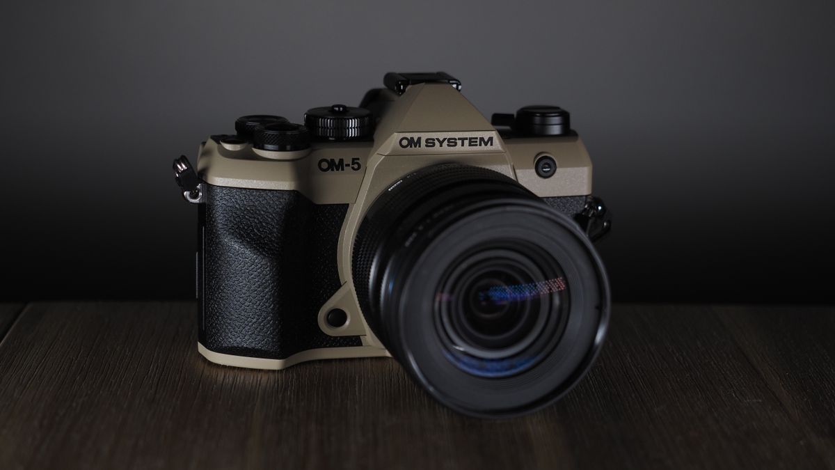OM System OM-5 Mark II on a wooden surface with an Olympus M.Zuiko 12-45mm lens