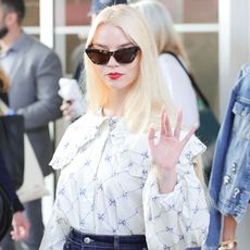 Anya Taylor-Joy appears in Cannes wearing cat-eye sunglasses and a white blouse with a frilly collar