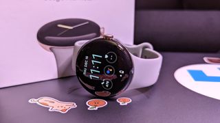 Google Pixel Watch with Lemongrass Google Pixel Watch Active Band on top of a laptop