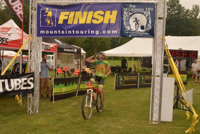 Matt Ferrari (Freeze Thaw-Hubcap Cycles) crosses the line as 2nd singlespeeder with his beer in hand
