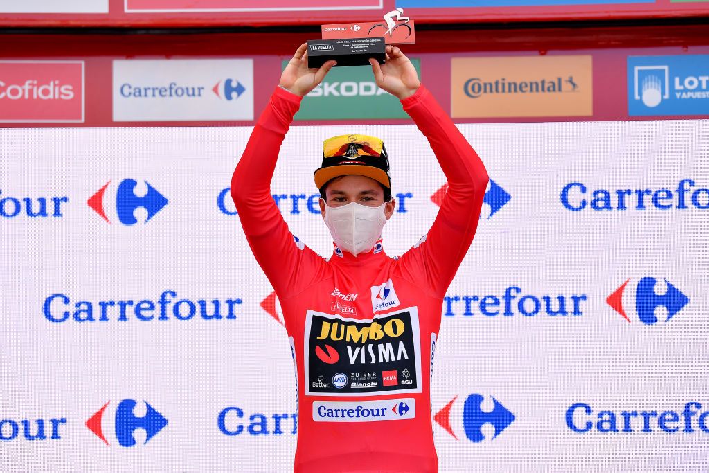 EJEADELOSCABALLEROS SPAIN OCTOBER 23 Podium Primoz Roglic of Slovenia and Team Jumbo Visma Red Leader Jersey Celebration Trophy Mask Covid safety measures during the 75th Tour of Spain 2020 Stage 4 a 1917km stage from Garray Numancia to Ejea de los Caballeros lavuelta LaVuelta20 La Vuelta on October 23 2020 in Ejea de los Caballeros Spain Photo by Justin SetterfieldGetty Images