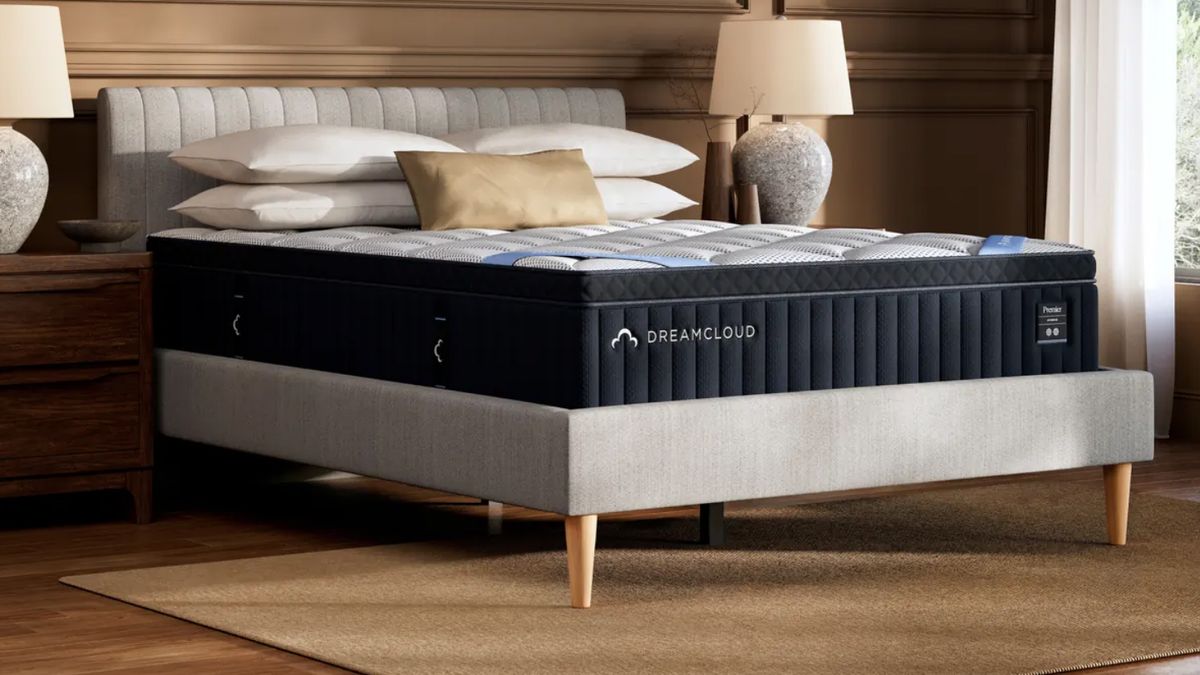 DreamCloud Premier Hybrid Mattress new for 2025 on top of a gray platform bed frame