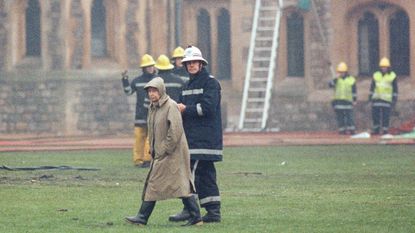 Queen Elizabeth surveys the damage at Windsor Castle after it caught fire