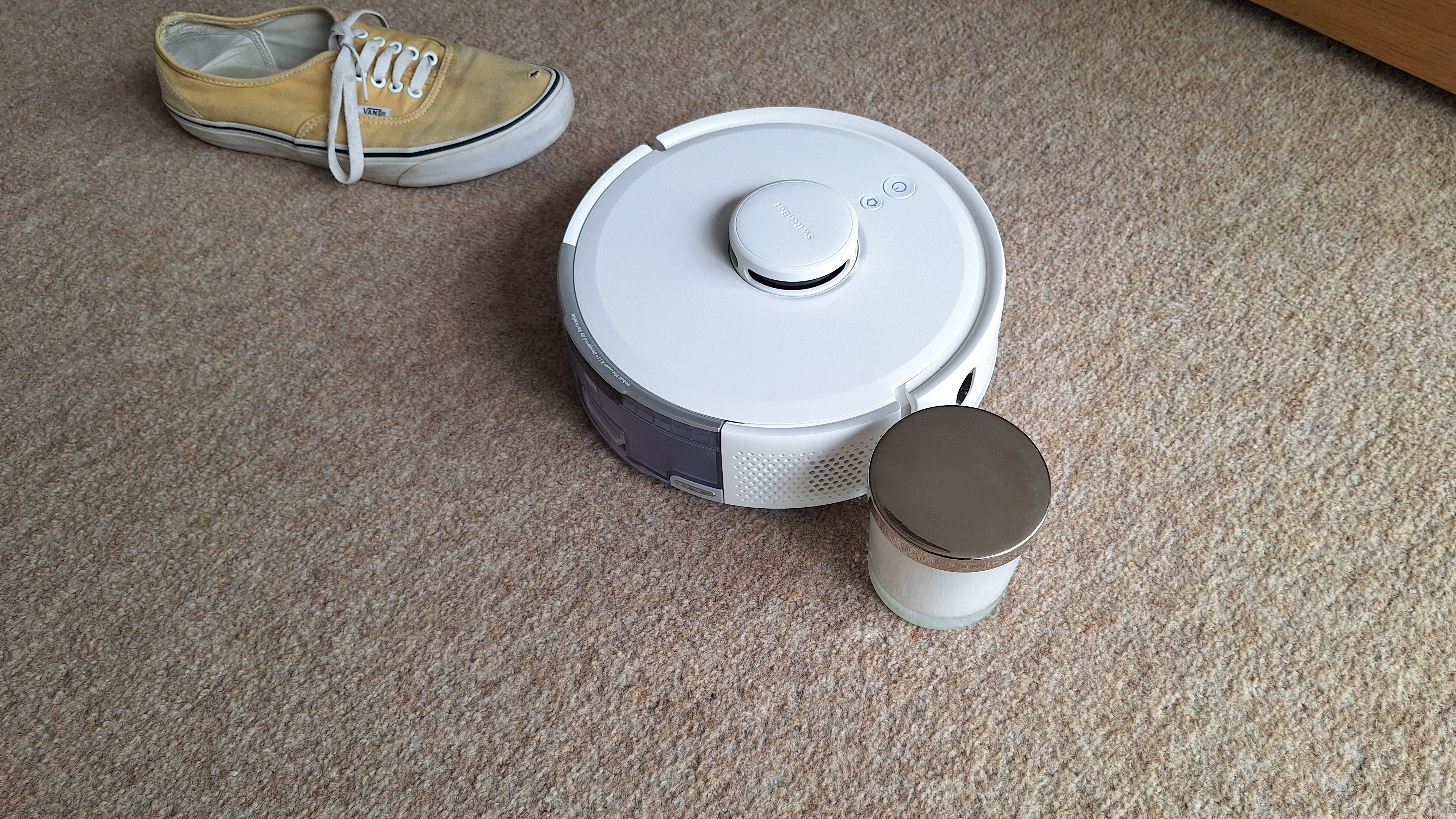 SwitchBot K11+ robot vacuum avoiding a candle