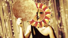 Photo collage of a woman, her face replaced by a vintage illustration of the Sun, hiding behind a paper mask of the Moon