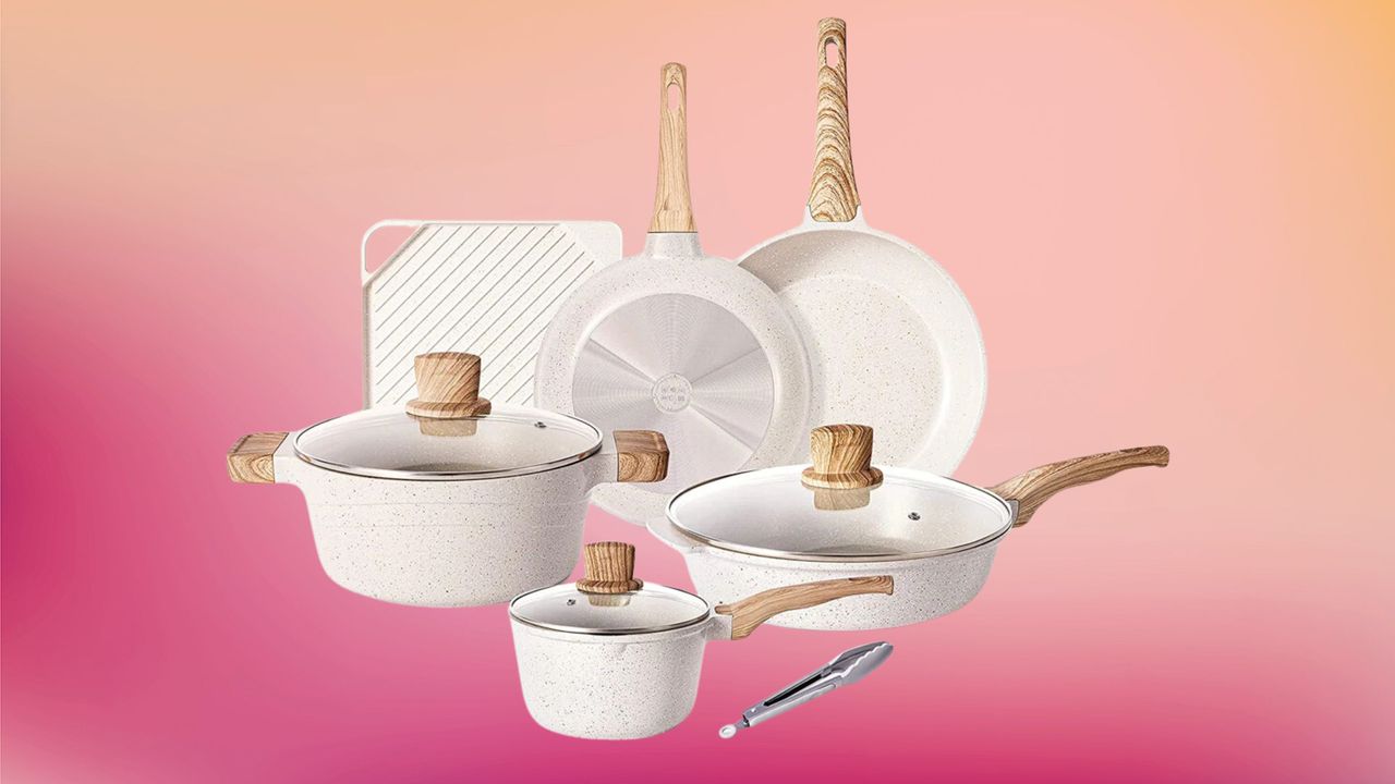 a set of white pans and pots with wooden handles