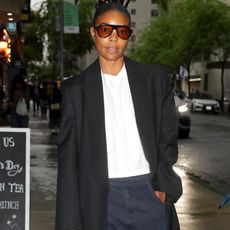 Gabrielle Union wearing a blazer coat, a white tee, and jeans 