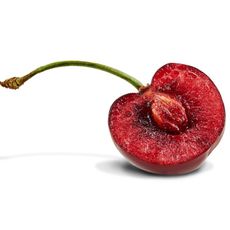 A cherry cut in half with the pit exposed