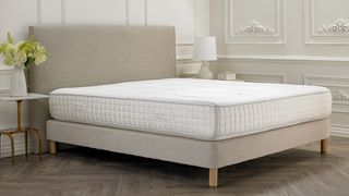 What mattresses do hotels use: the white medium-firm Sofitel mattress photographed on a light beige fabric bedframe